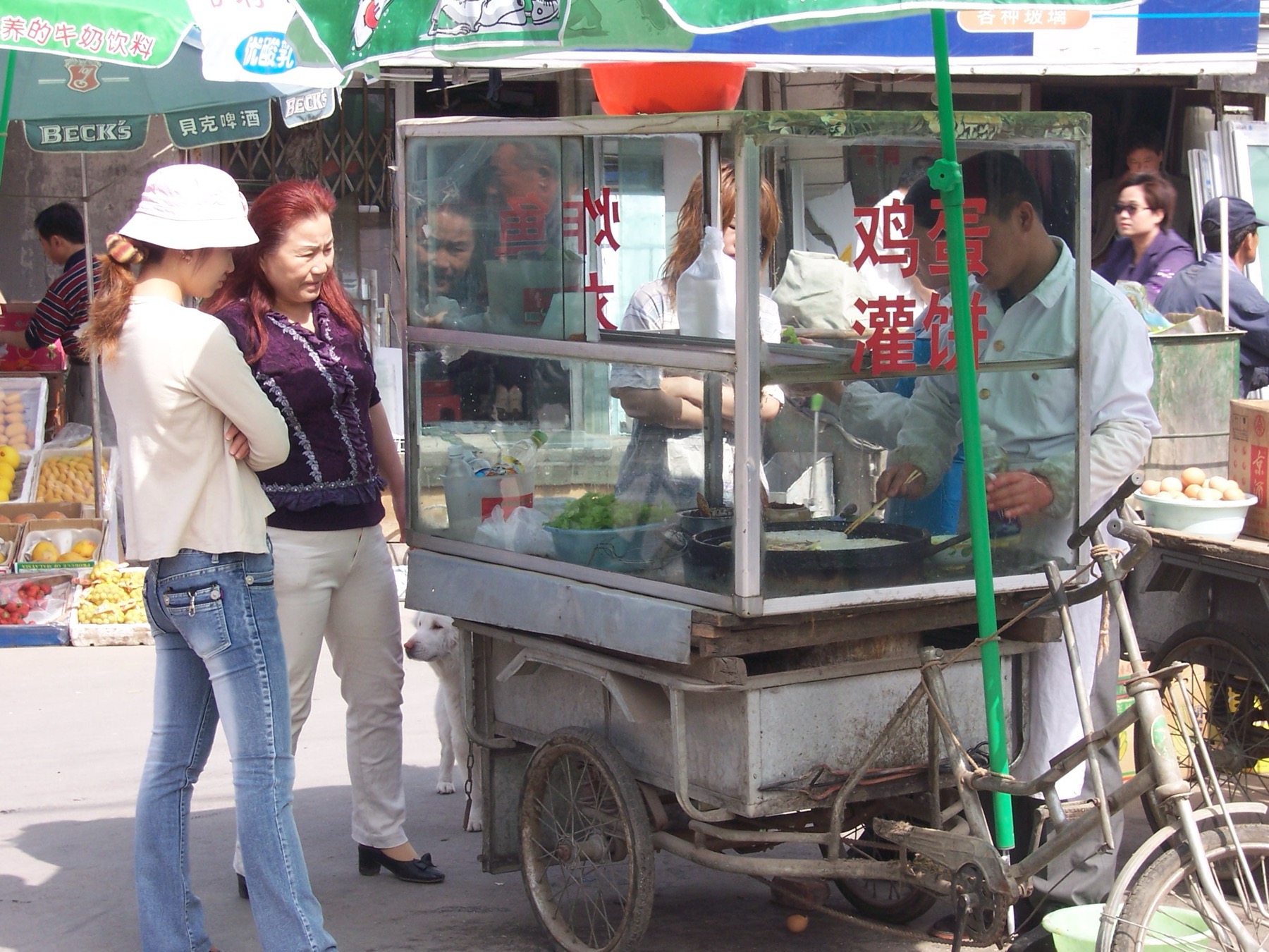 A Beijing street vendor preparing egg-filled pancakes at a breakfast stall