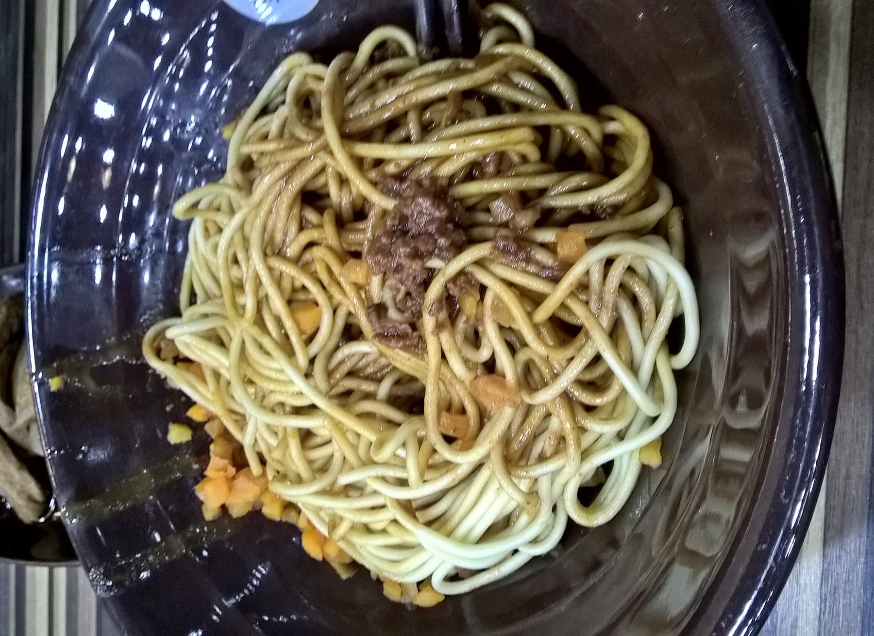 A bowl of Wuhan hot dry noodles coated in sesame-rich sauce