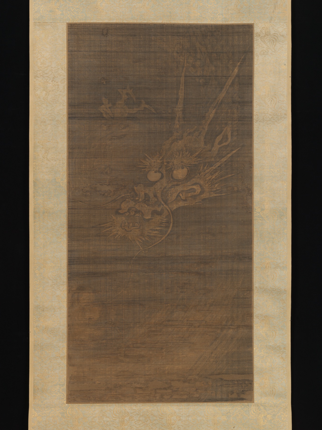 A fourteenth-century dragon coils through patterned space, revealing the motif’s graphic complexity.