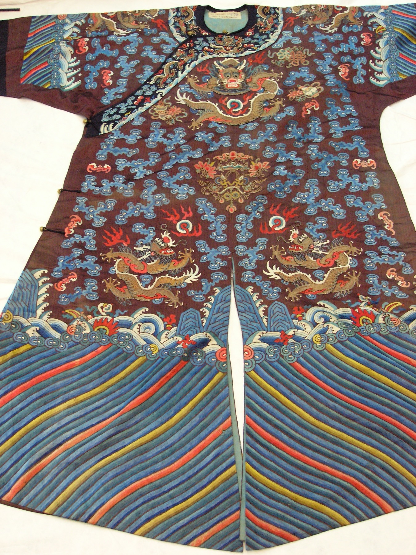 Gold-thread dragons animate a late Qing formal robe embroidered in multicolored silk.