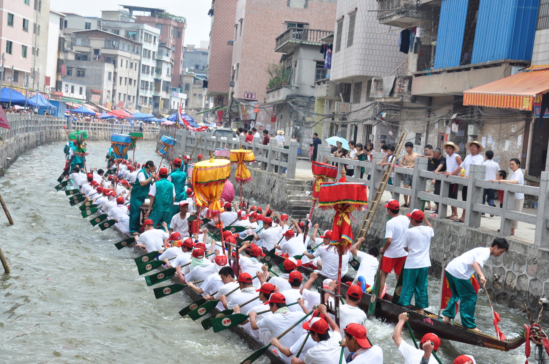 Crews race dragon boats on a waterway in Datang, Guangzhou.