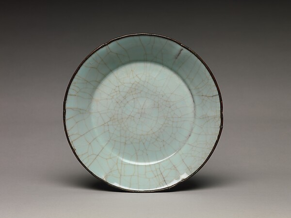 A Southern Song Guan ware dish turns a network of glaze cracks into a quiet composition.