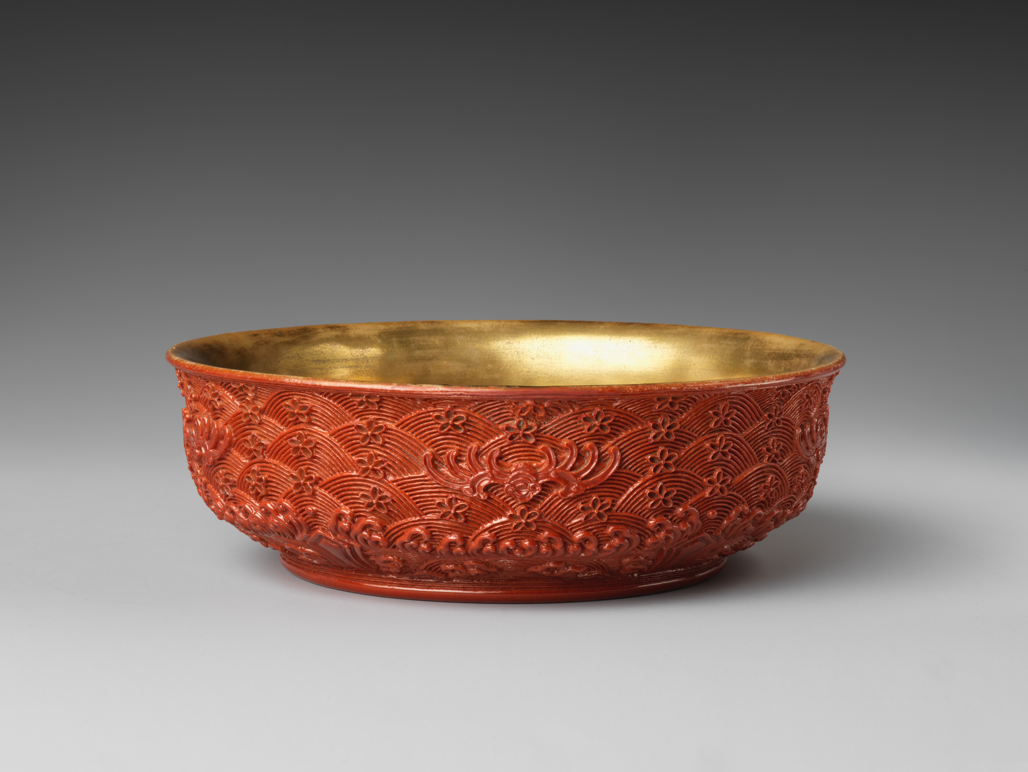 Qing dynasty bowl whose surface imitates the appearance of carved lacquer.