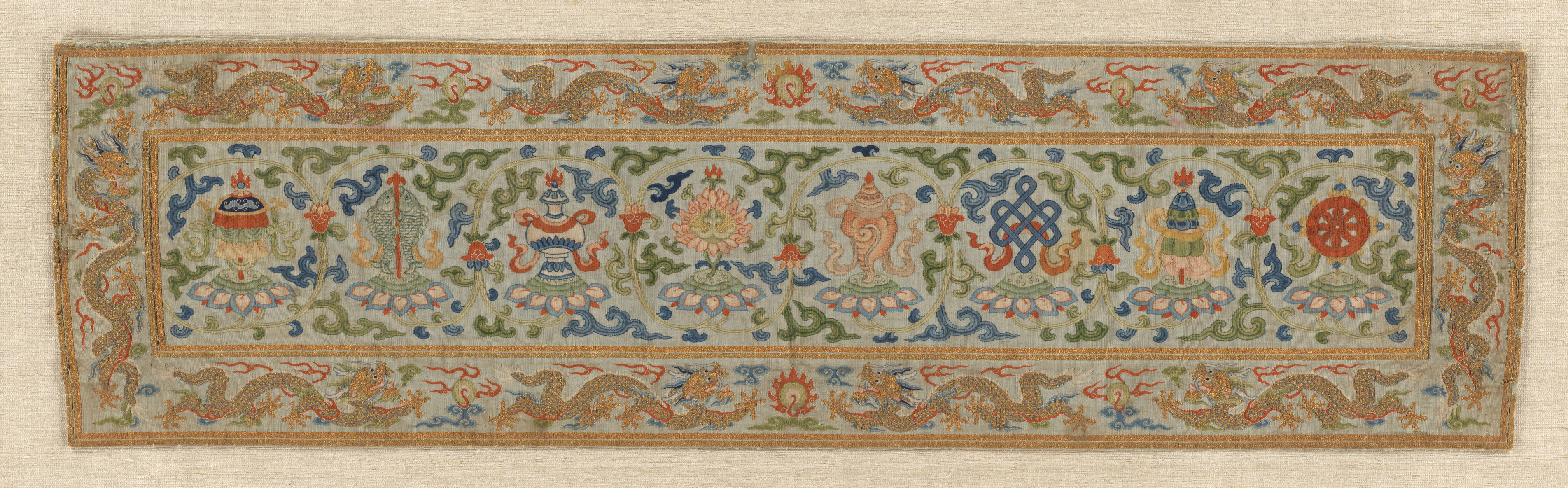 Qing silk tapestry displaying eight auspicious Buddhist emblems on lotuses.