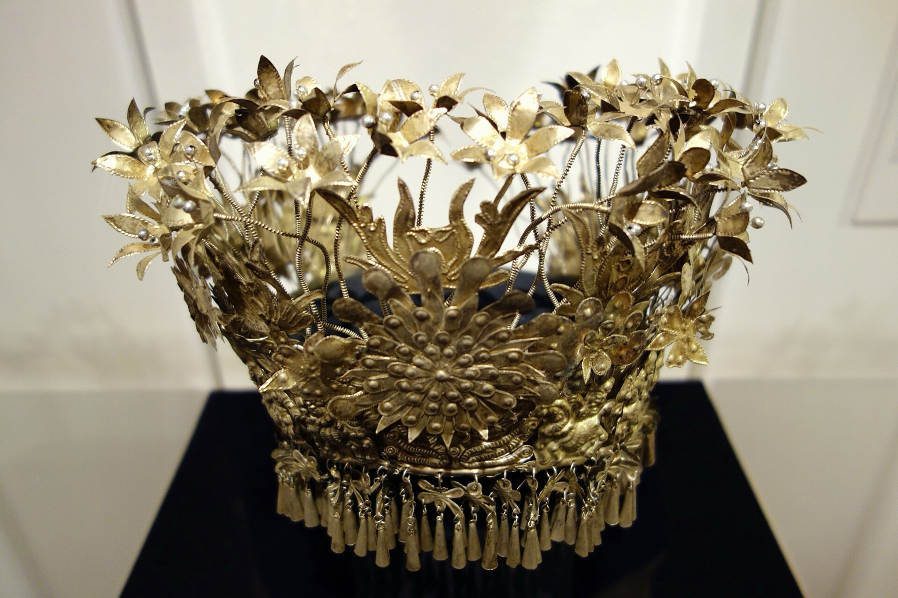 A mid-twentieth-century Miao woman’s headdress from Guizhou combines silver, glass beads and wire.