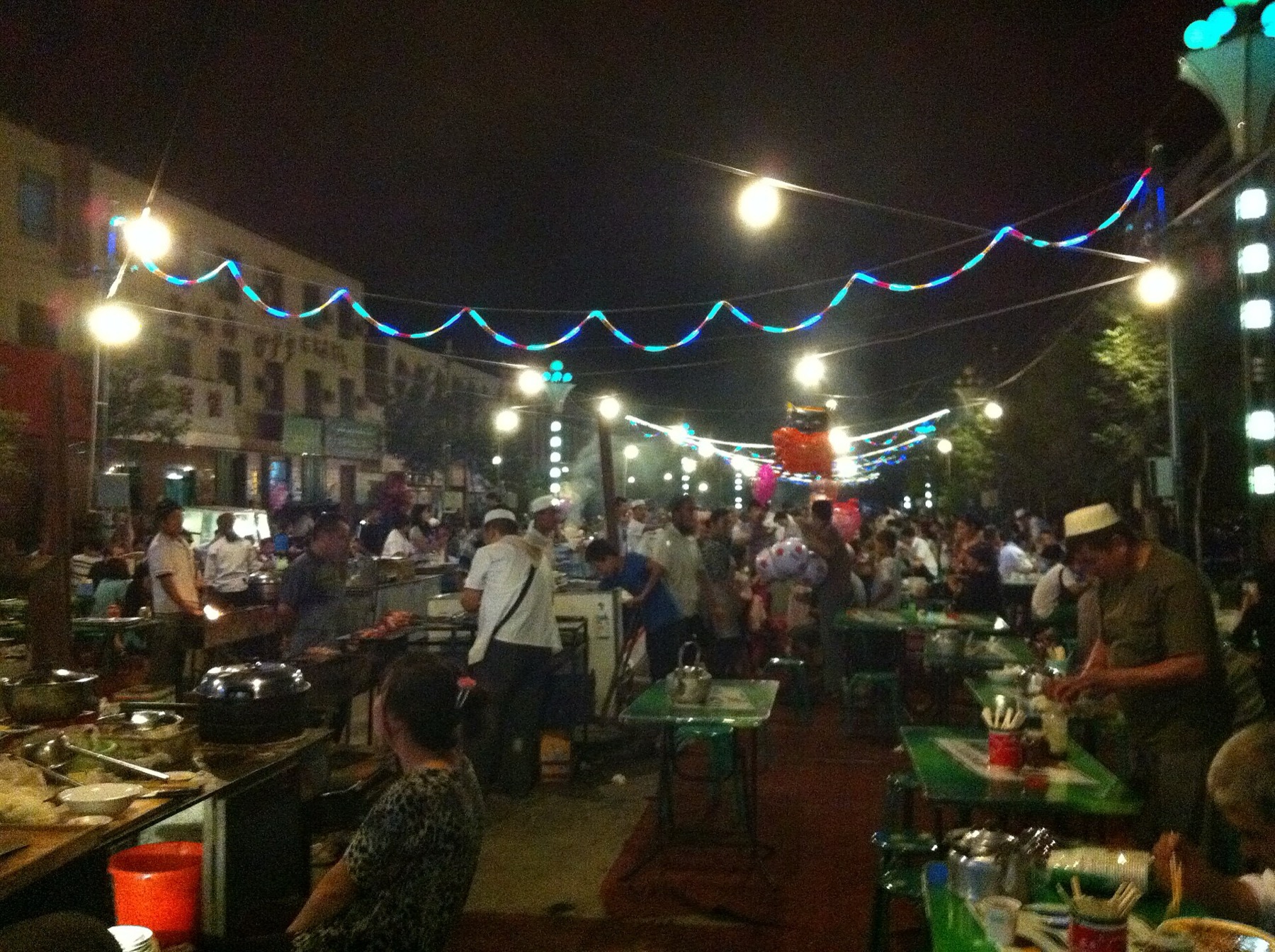Vendors and customers gather at a night market in Shanshan, Xinjiang.