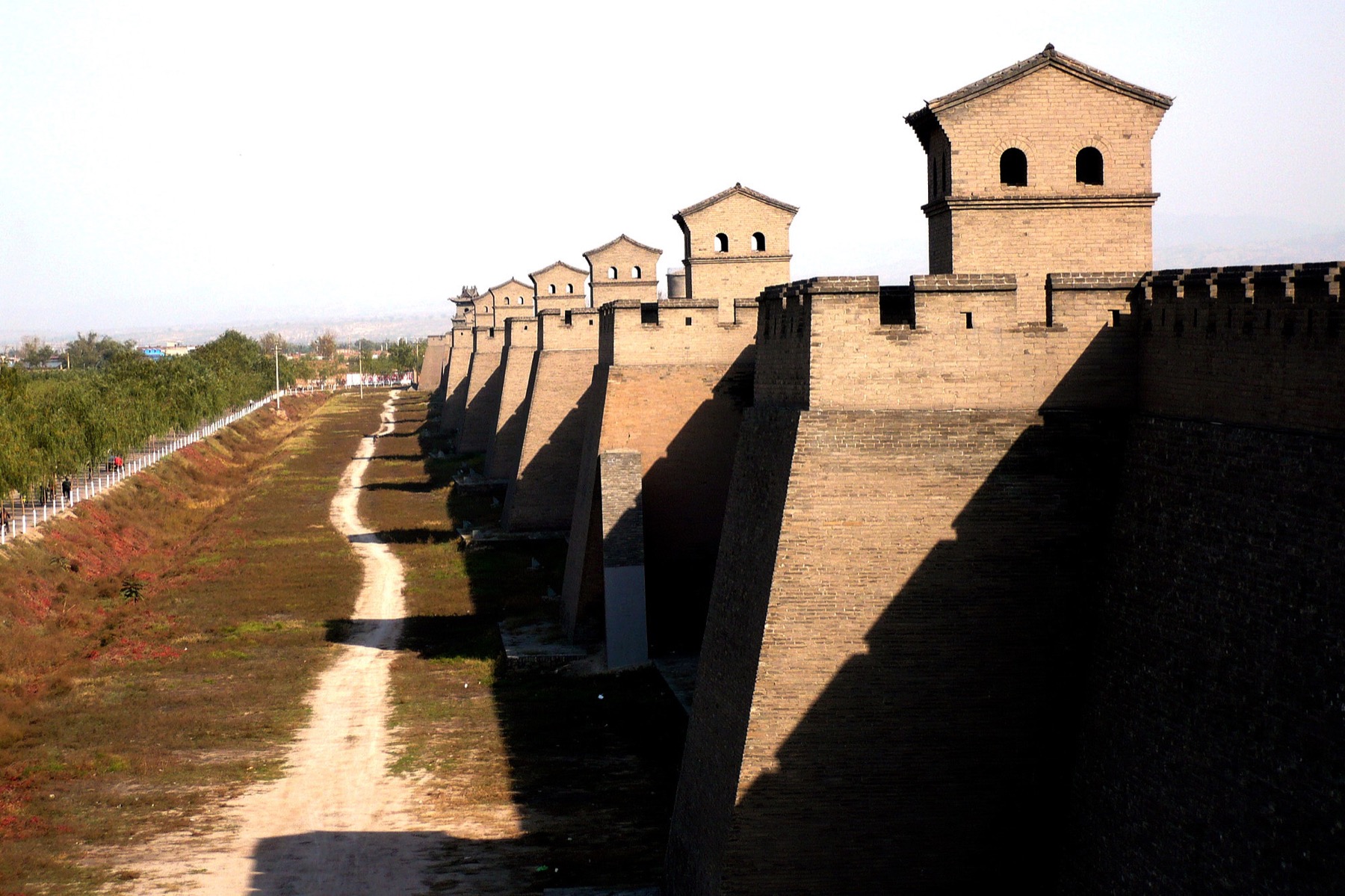 Pingyao’s masonry wall and watchtower establish the old city as a legible whole.