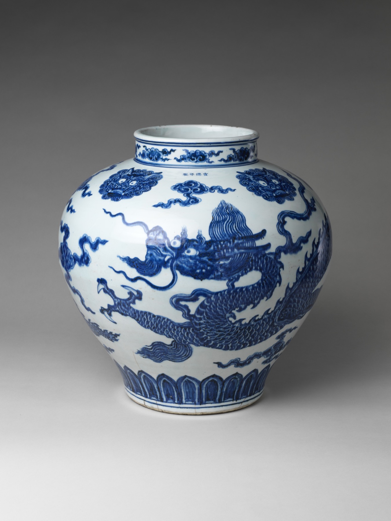 A dragon moves through cobalt clouds on an early Ming blue-and-white porcelain jar.