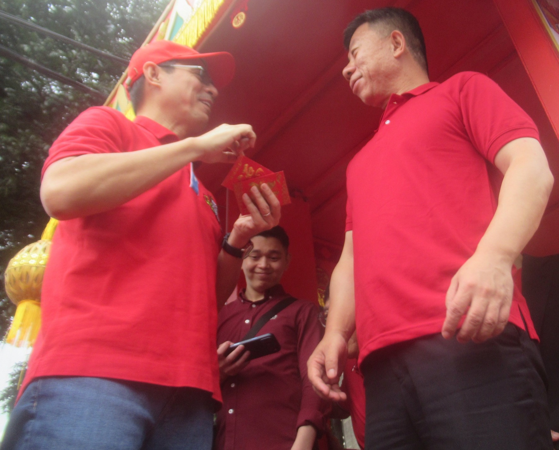 A red envelope is presented during a Filipino-Chinese Lunar New Year gathering in Manila.