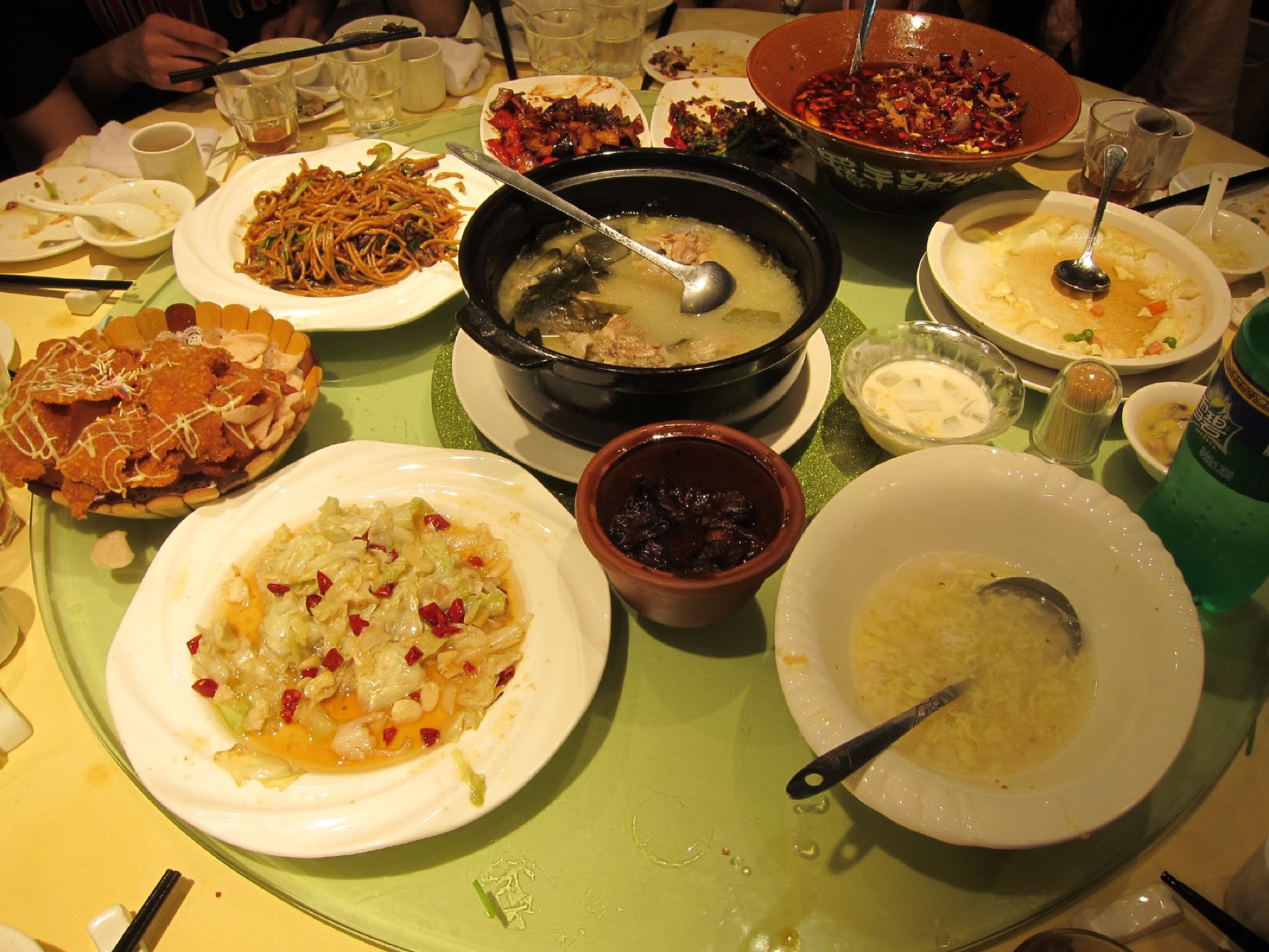 Shared dishes are arranged on the rotating center of a group dining table in China.