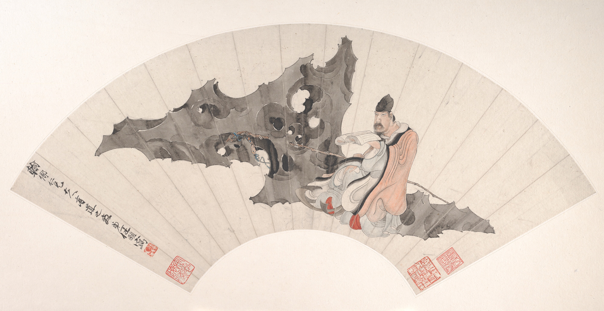A scholar reading beside an eroded garden rock in a fan painting by Ren Yi.