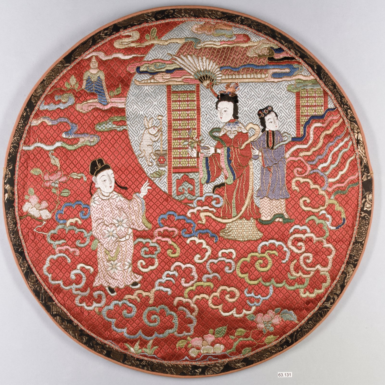 Embroidered mirror case with a lunar garden scene.